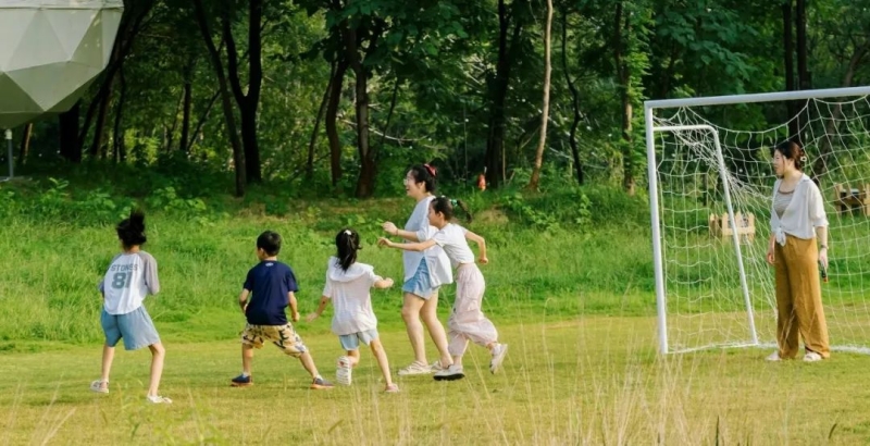 A group of people playing a game of soccer